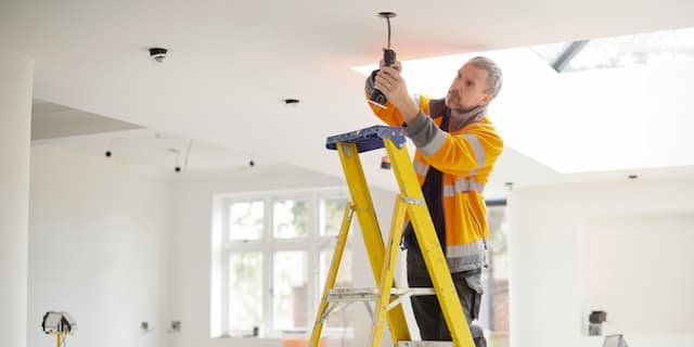 Electrician Installing Recessed Lighting in New Construction